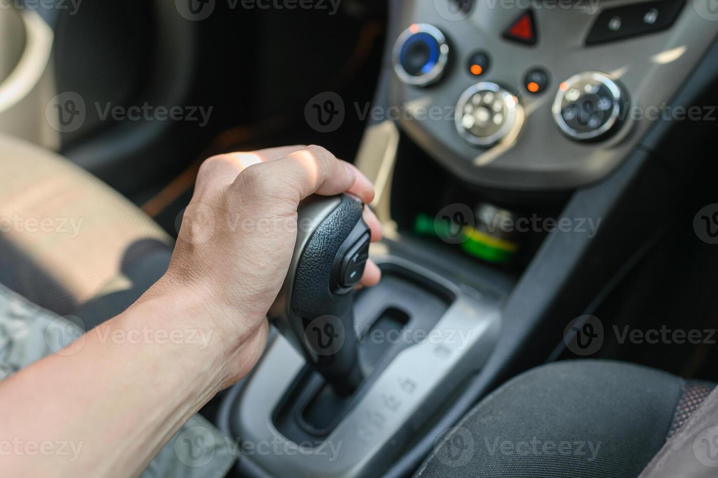 Driver male hand holding automatic gear shift photo
