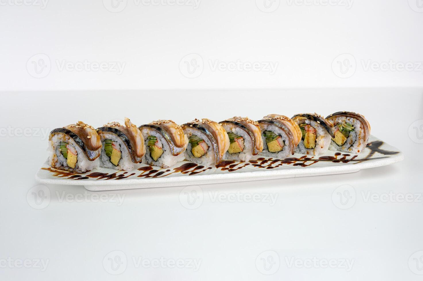 Saba smoked filled avocado, tamago, kani, cucumber pickle sushi roll with teriyaki sauce photo