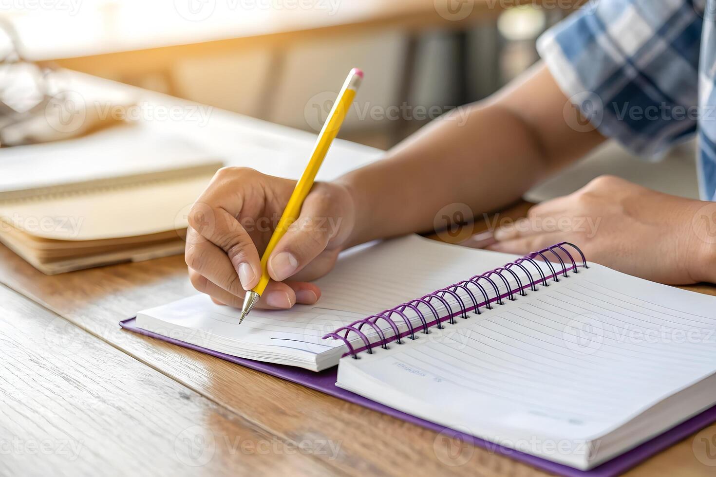 A student writing in a notebook photo