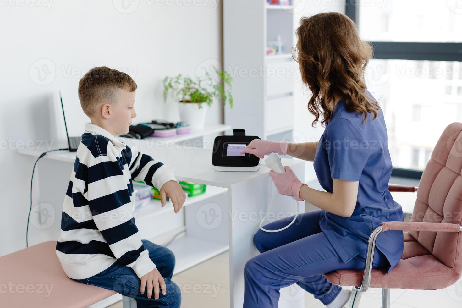 Boy testing breathing function by spirometry in doc office. Diagnosis of respiratory function in pulmonary disease. photo