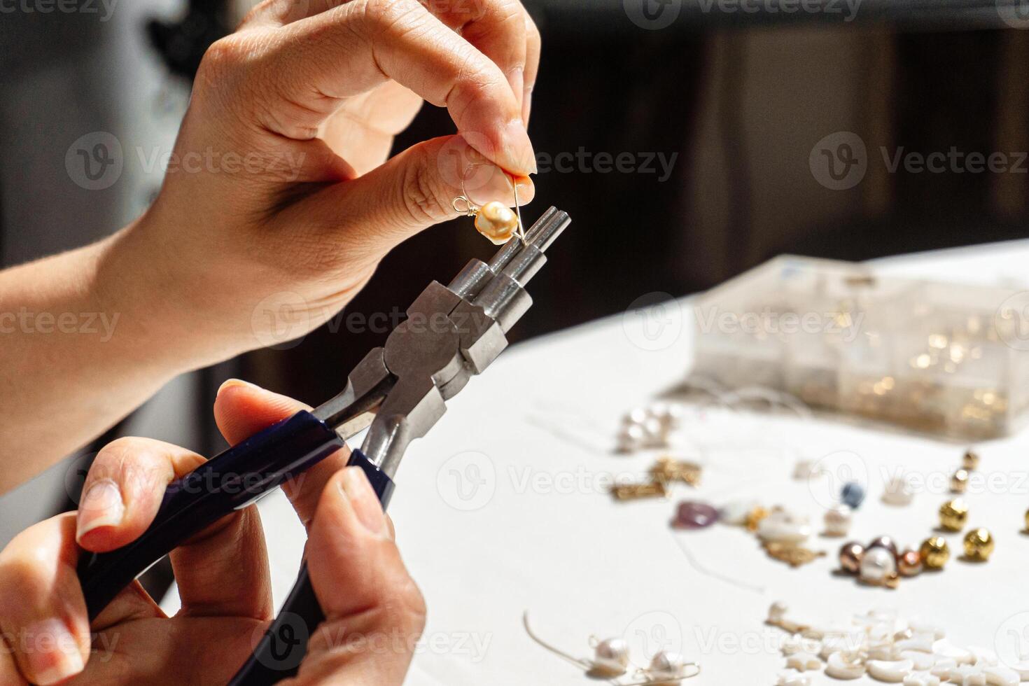 A Hands of a person using round nose multipurpose pliers. photo