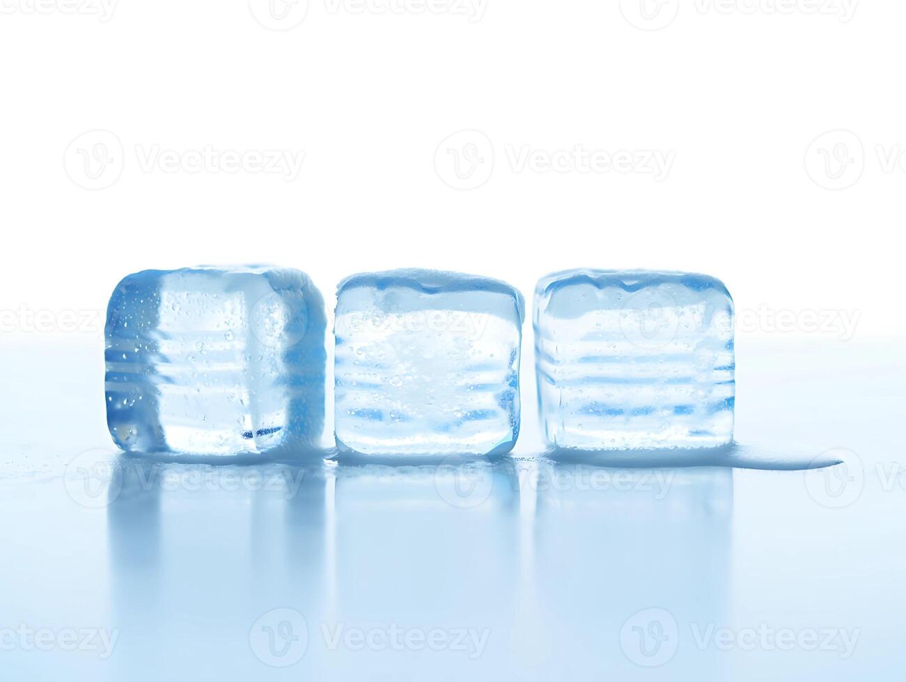 Three Melting Ice Cubes on Reflective Surface photo