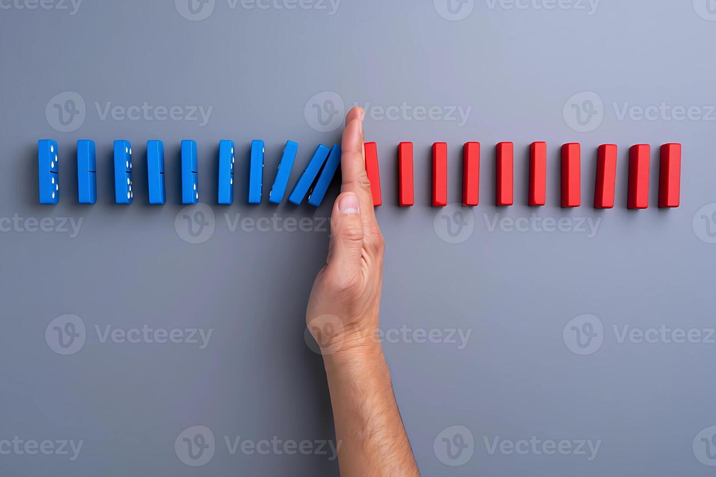 Halting the Cascade A Hand Stops the Domino Effect photo