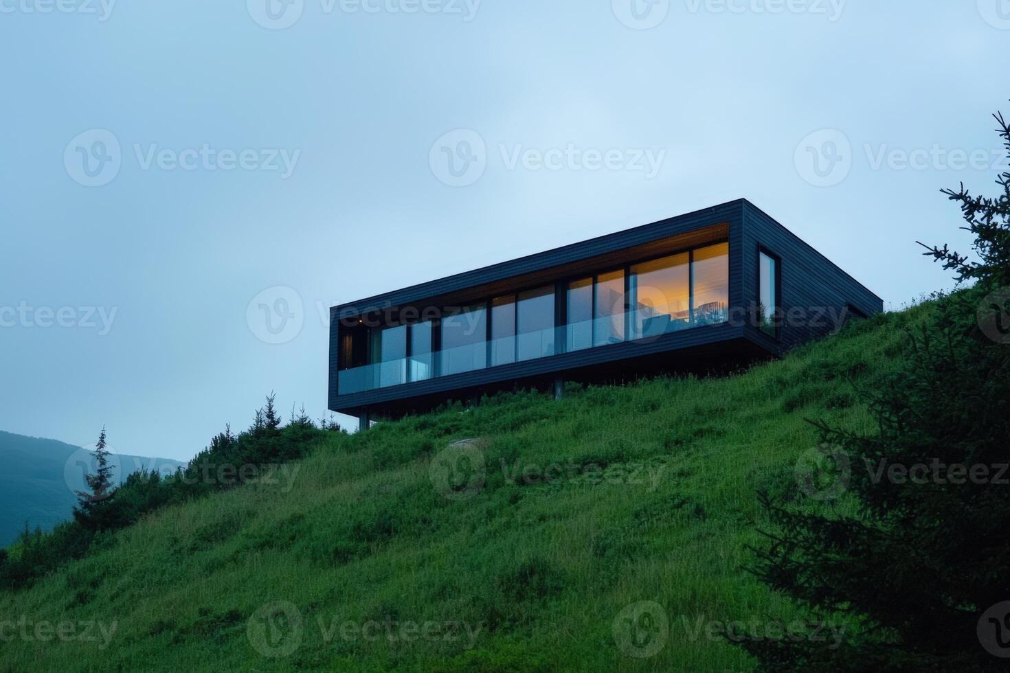 Modern cabin overlooking a lush hillside during twilight in a tranquil setting photo