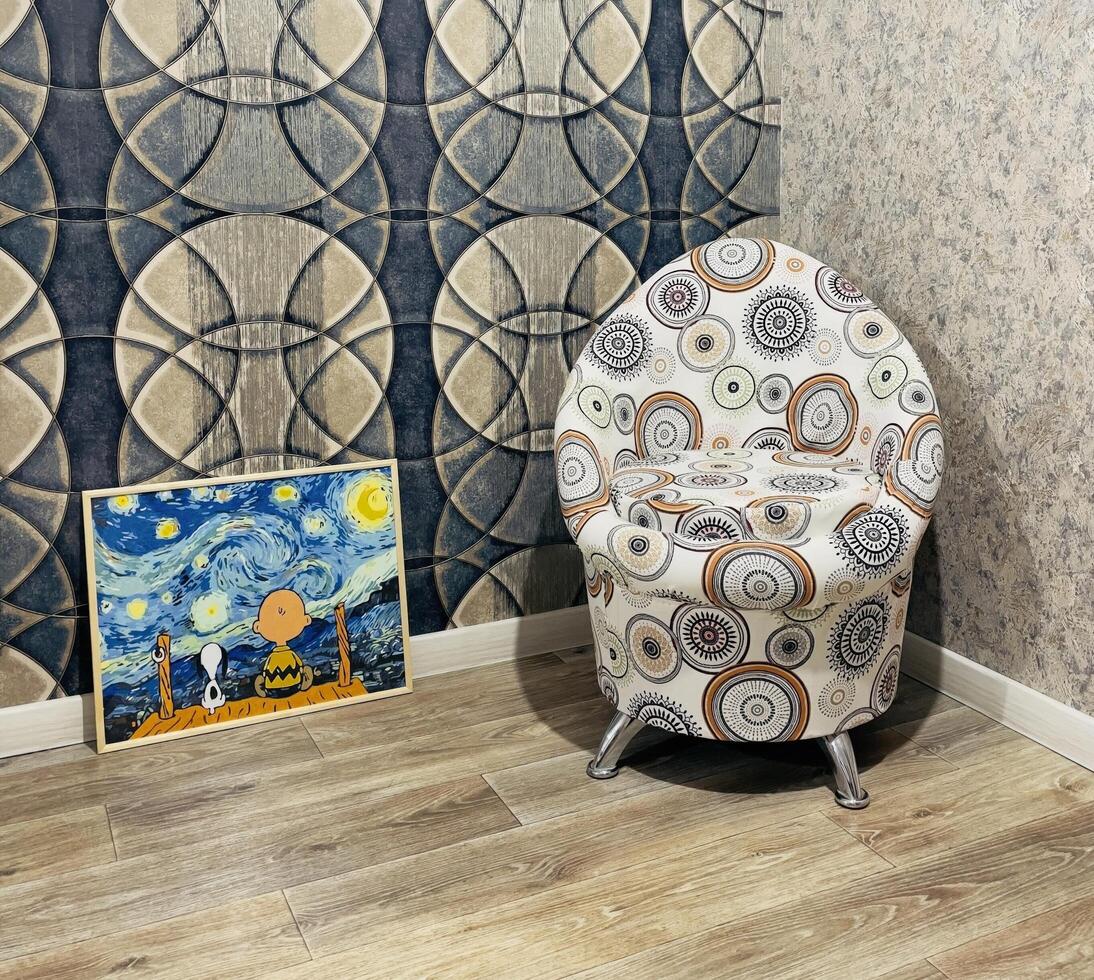 Artistic corner featuring a unique chair and a whimsical painting in a cozy room with creative design elements photo
