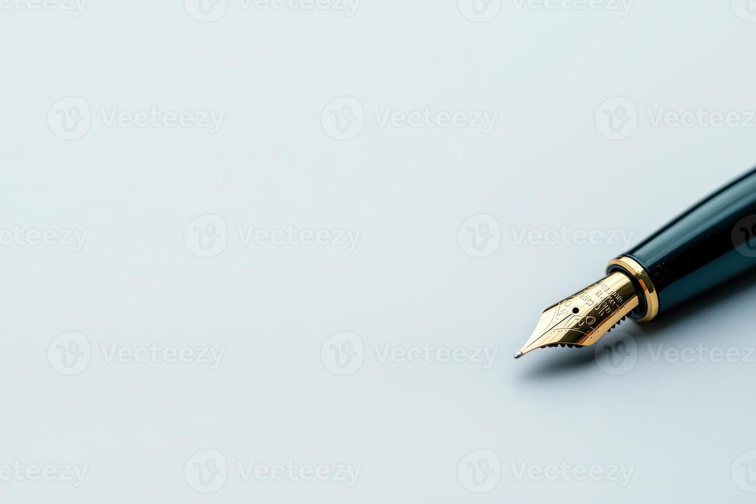 Elegant fountain pen poised on pristine white surface during a creative writing session photo