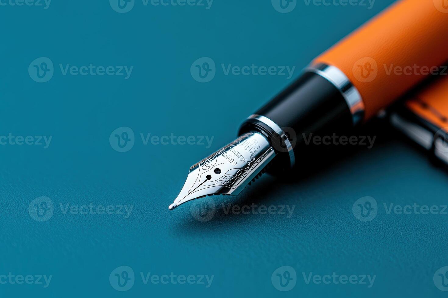 Fountain pen and notebook on a blue surface for creative writing and note-taking photo