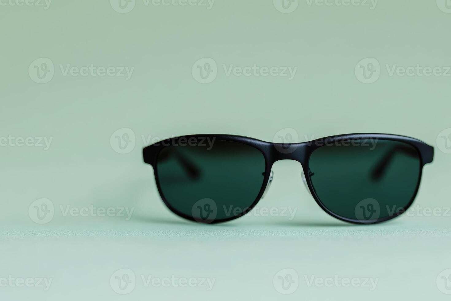 Stylish black sunglasses on a light green background create a modern look photo