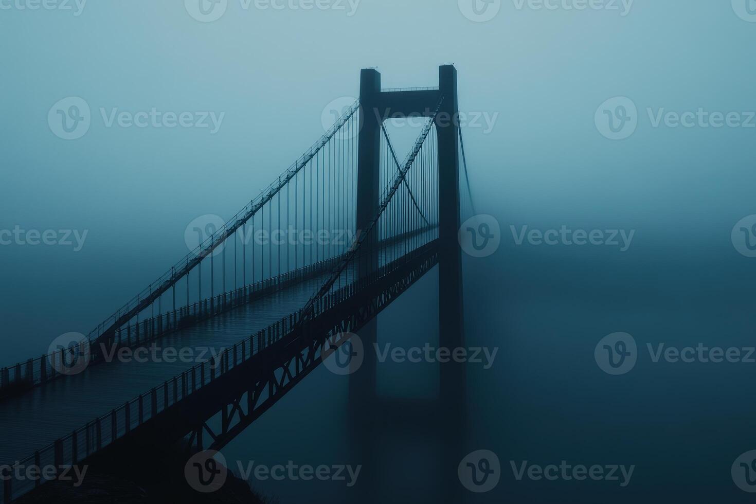 Mist envelops bridge at dawn creating an ethereal atmosphere over the landscape photo