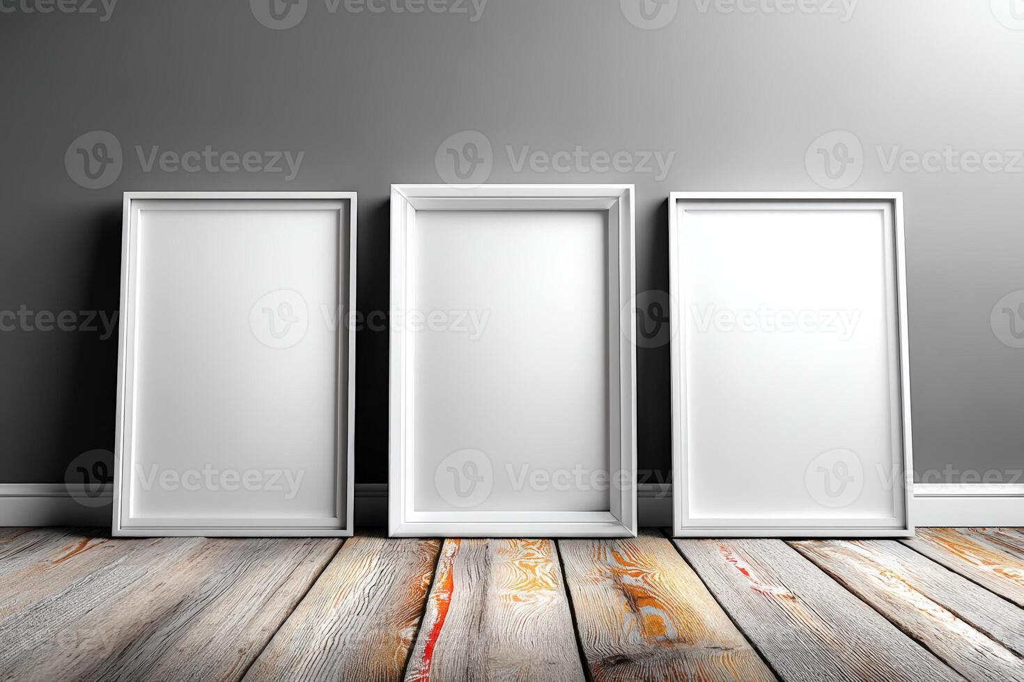 Blank frames arranged on a wooden floor against a gray wall ready for artwork or photos