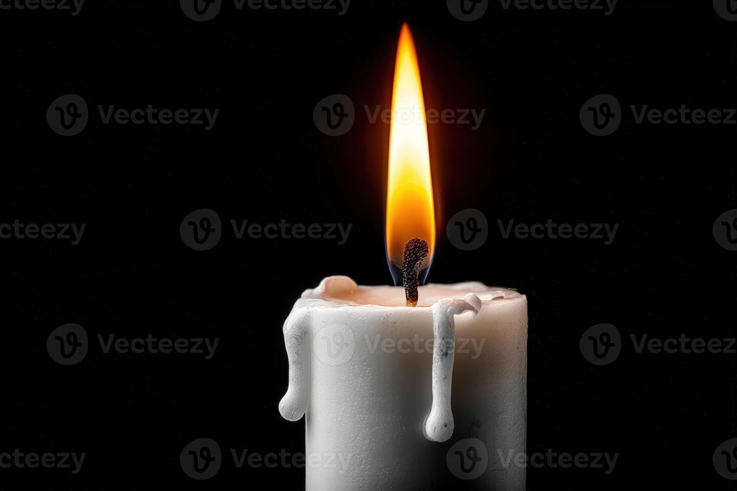 Candle flame casting warm light and shadows in a dark setting at night photo