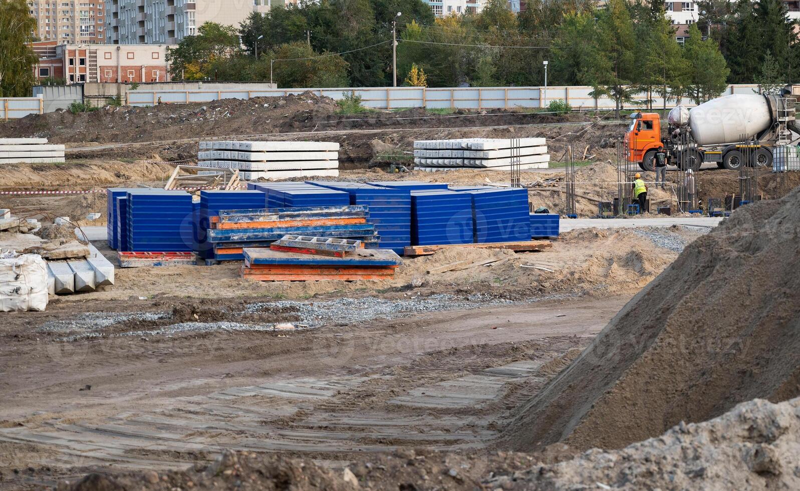 Concreting work at the construction site. Construction workers pour liquid concrete from cement concrete hopper to formwork installation. photo