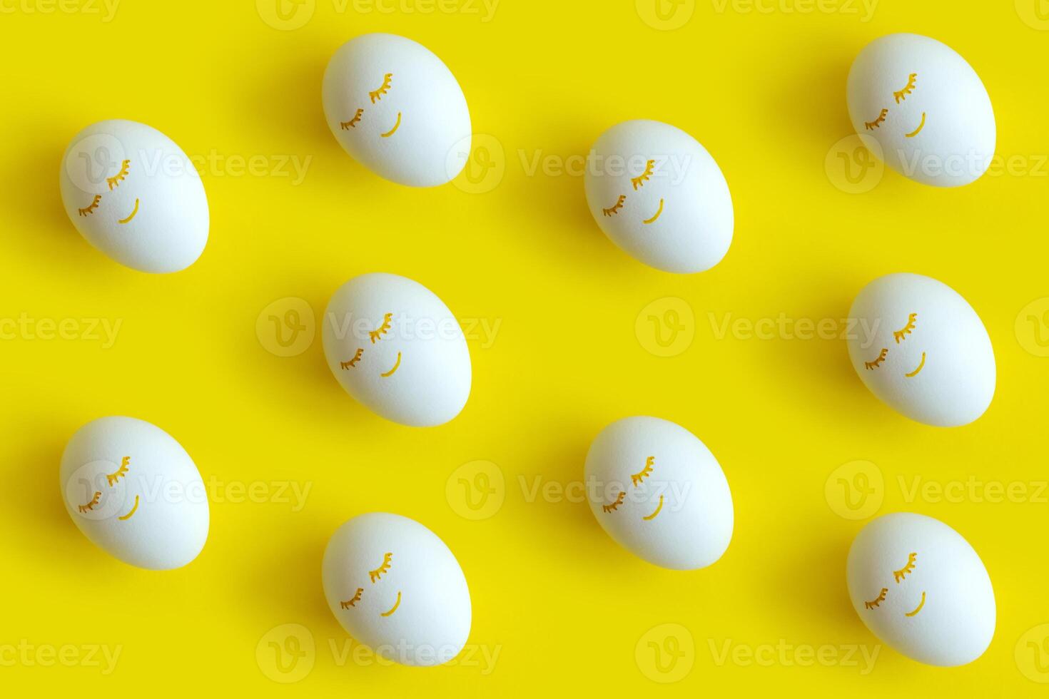 Easter eggs pattern on colorful yellow background. Top view, flatlay. photo