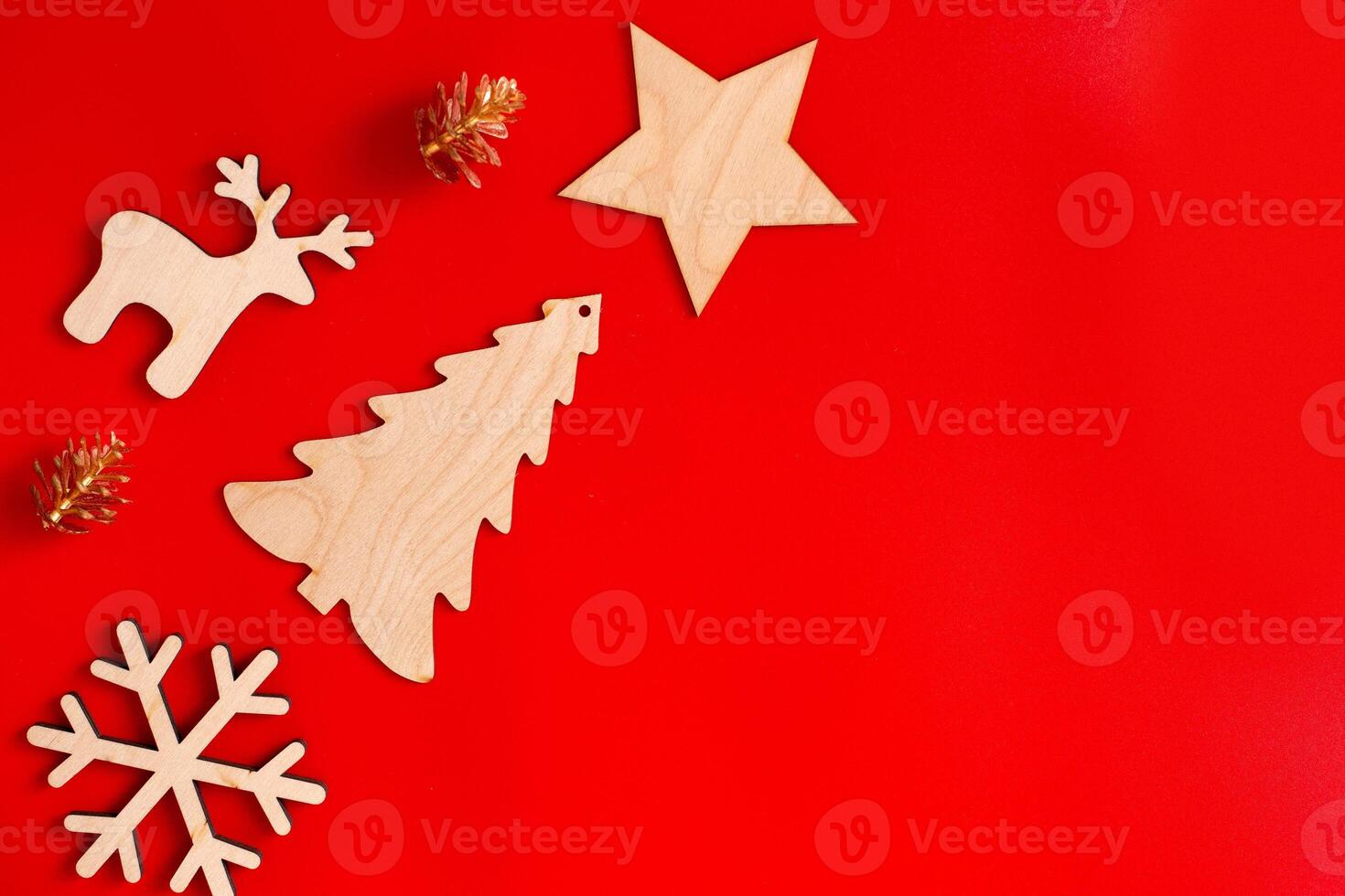 Flat natural unpainted wooden christmas ornaments lie diagonally on red background photo
