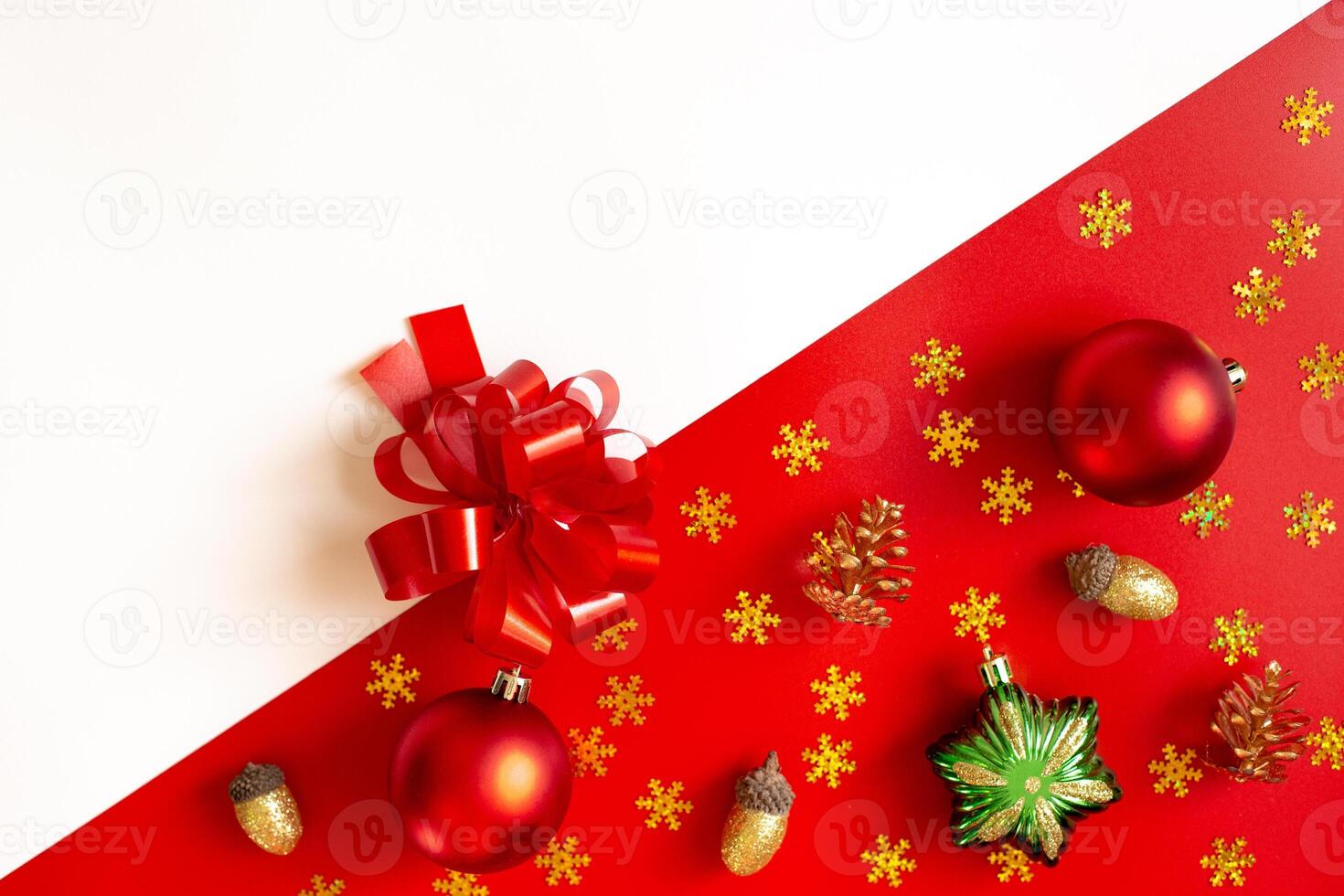 Diagonally red and white background of Christmas decorations, plastic bow and colored toys. photo