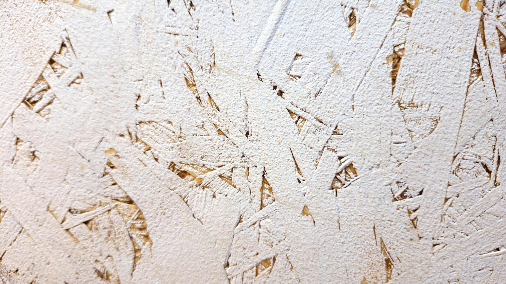 Textured close-up of white painted osb wood panel surface photo