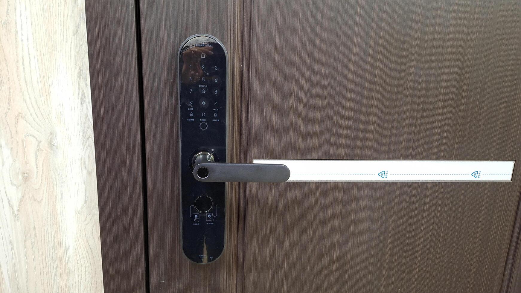 Moscow, Russia - November 27, 2024,Smart digital door lock with handle and access card for security and convenience photo