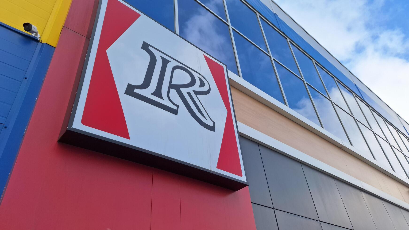 Moscow region, Russia - April 12, 2025.The large logo of the Rostics restaurant outside the modern building photo