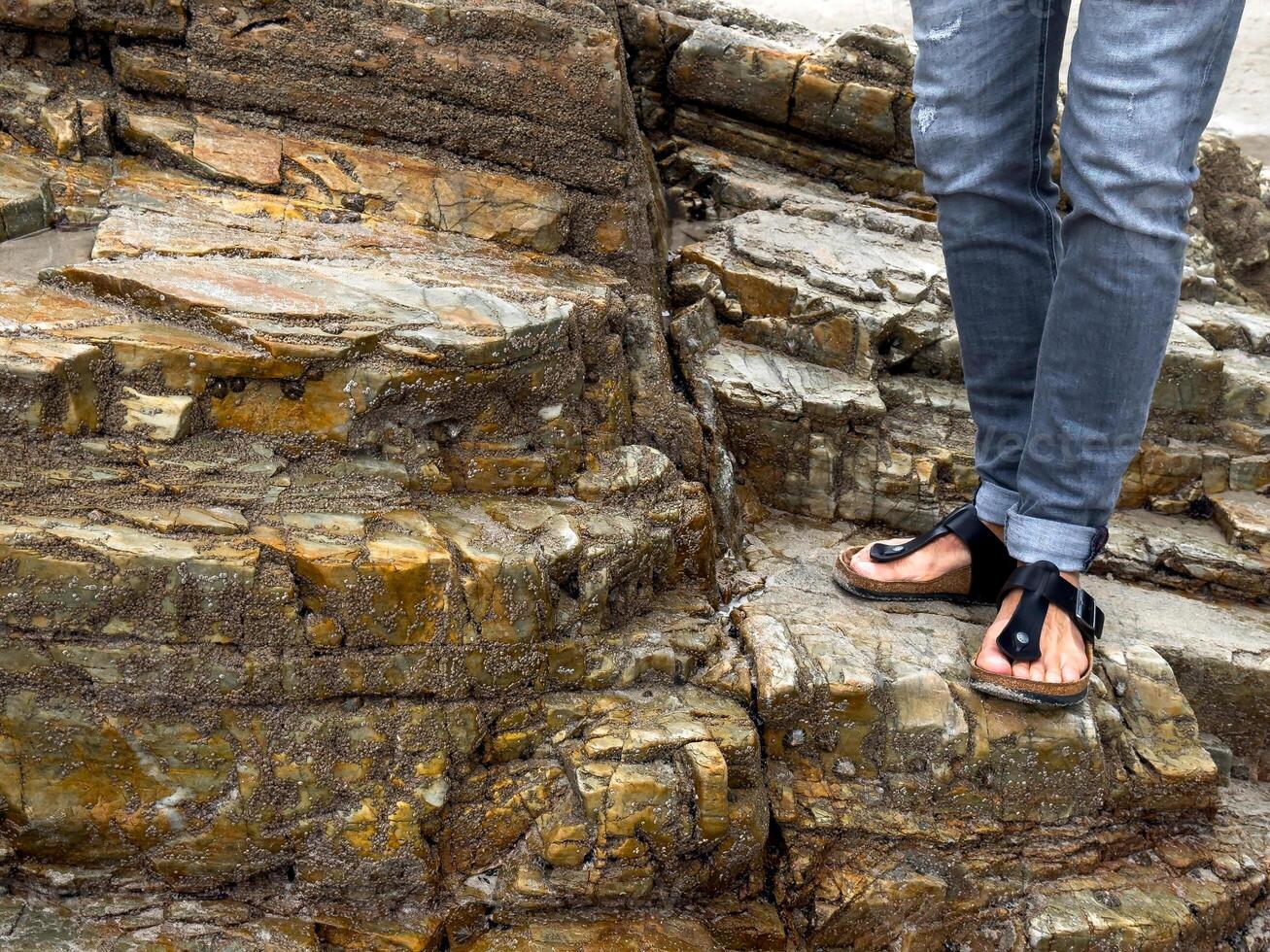 Casual footwear on rocky terrain by the beach photo