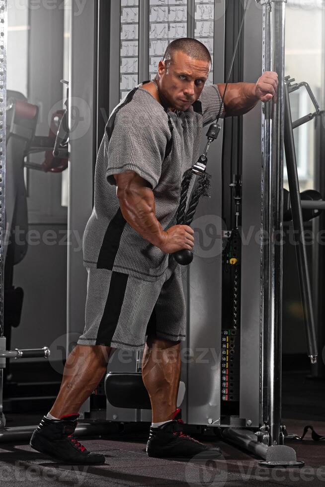 professional bodybuilder executes a cable exercise in a well equipped gym focusing on improving muscle tone and overall strength during an intensive training session photo