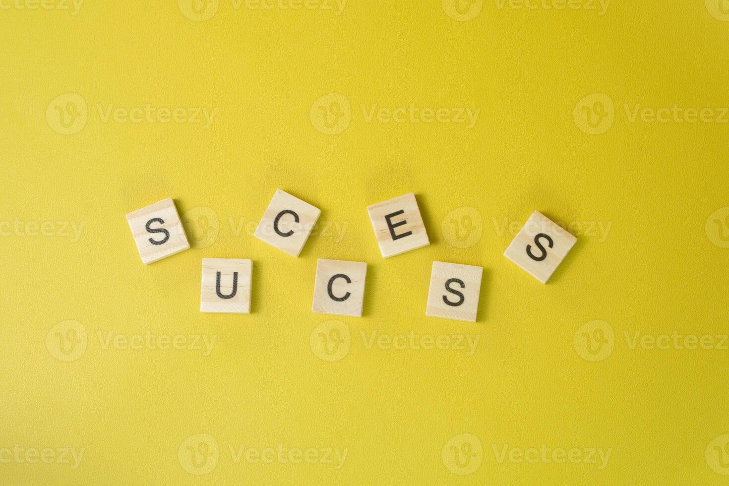 Scattered Wooden Letters Forming the Word SUCCESS on Yellow Background Puzzle of Progress Concept photo