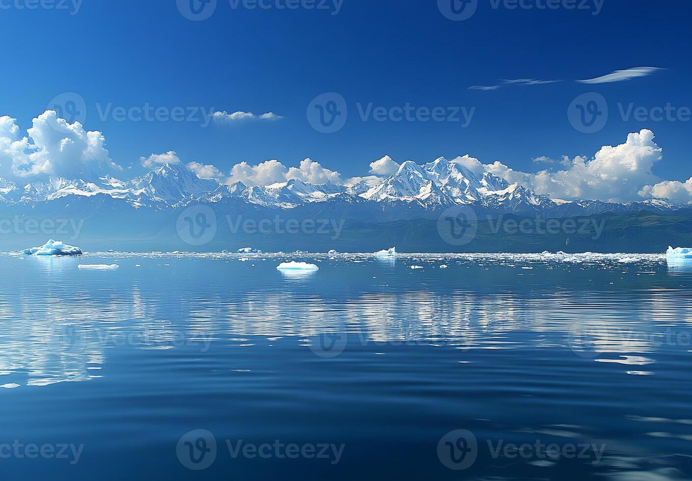 Majestic snow capped mountains reflected in a calm glacial lake photo
