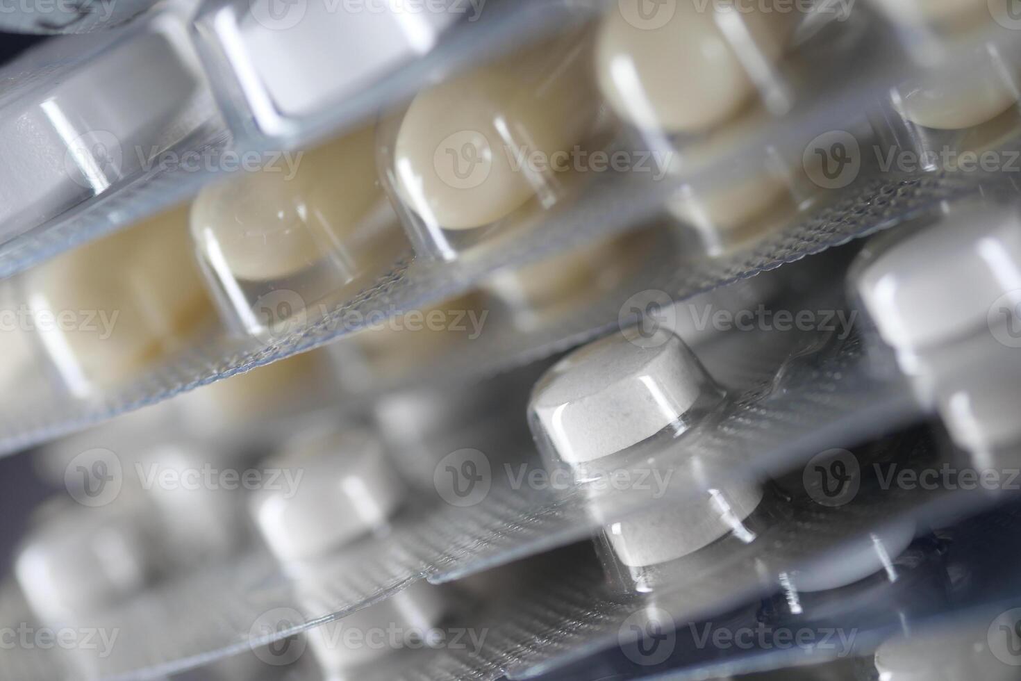 Close-up view of various medicine blister packs stacked together photo