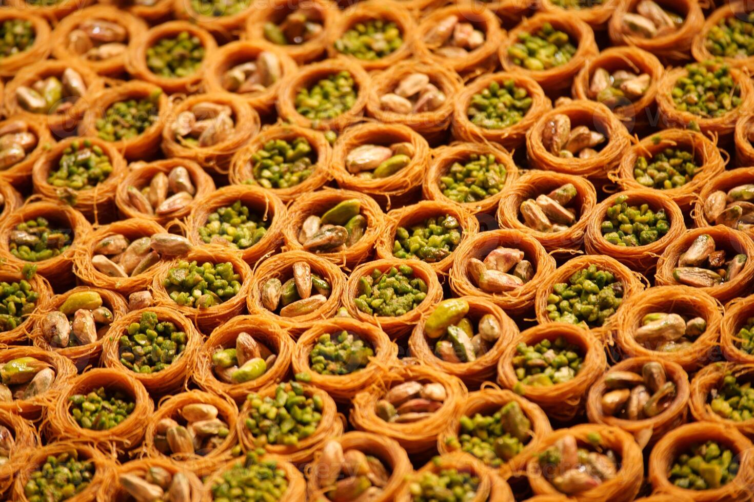 Delicious turkish baklava filled with nuts displayed at market photo