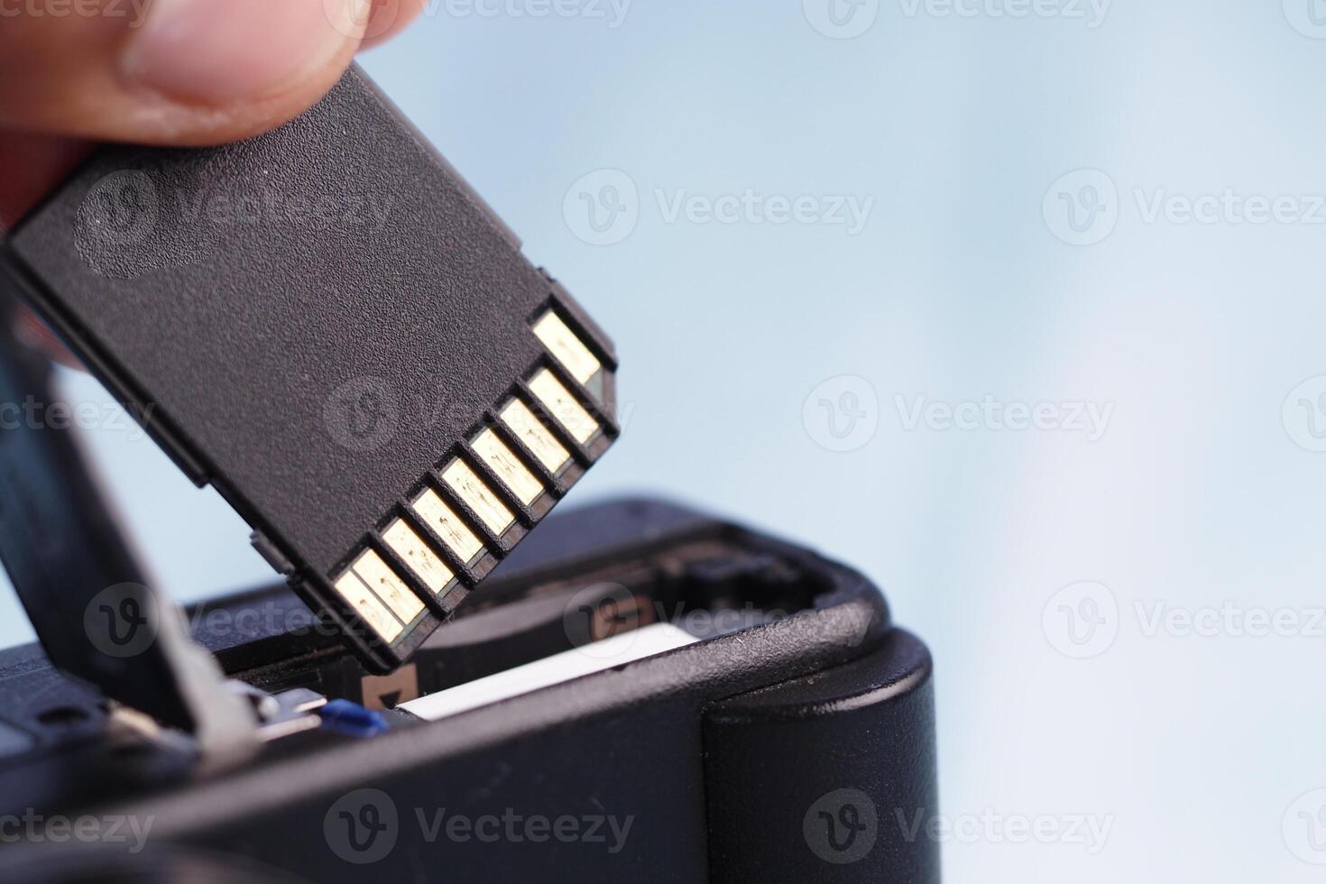 Removing a memory card from a digital camera for data transfer photo
