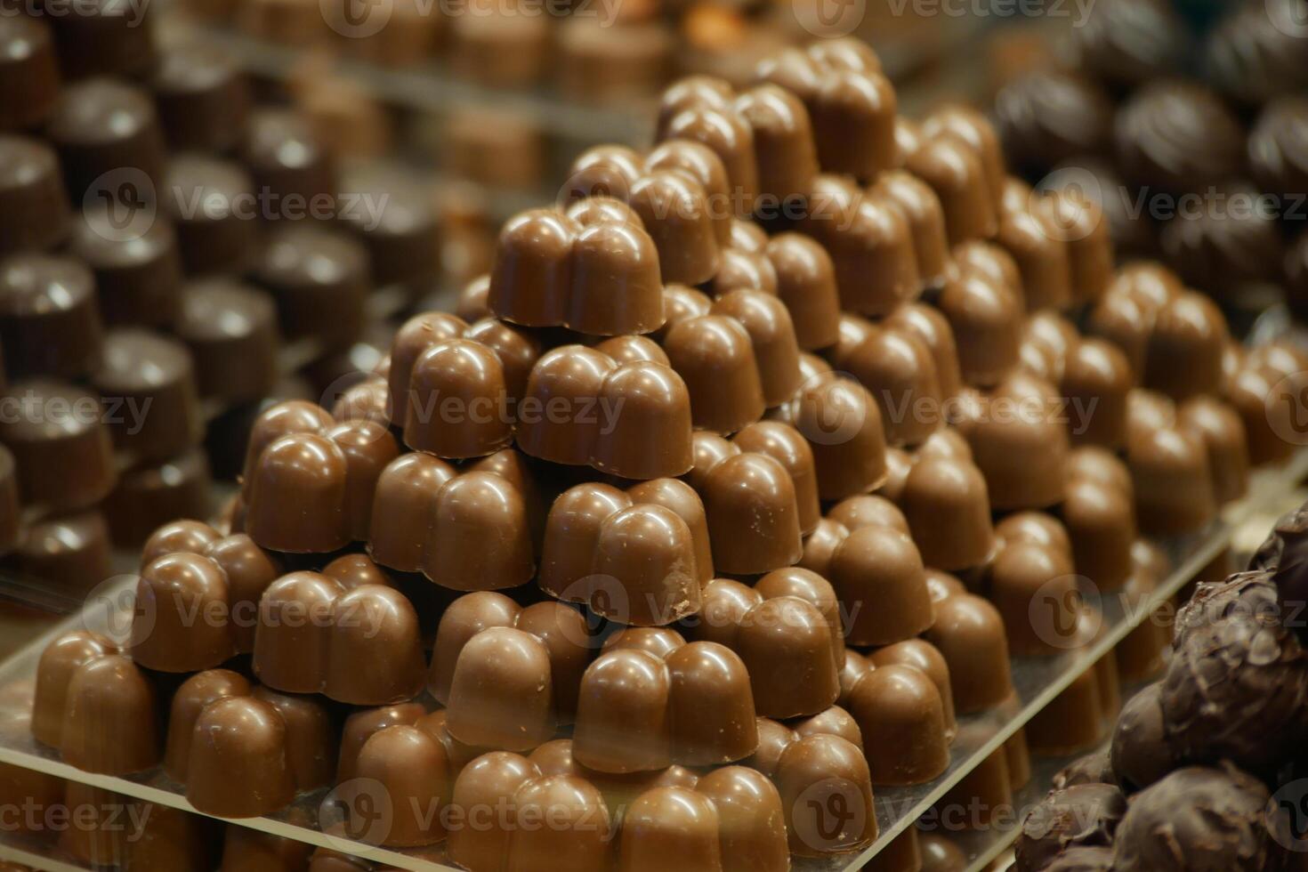 Chocolate candies arranged in decorative pyramid shape in store photo