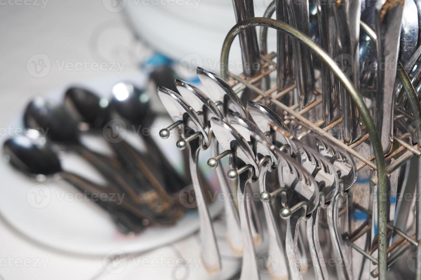 Silver utensils neatly arranged in a kitchen setting for dining photo