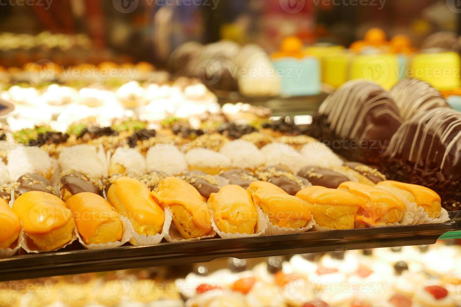 Colorful selection of pastries displayed in a dessert shop photo