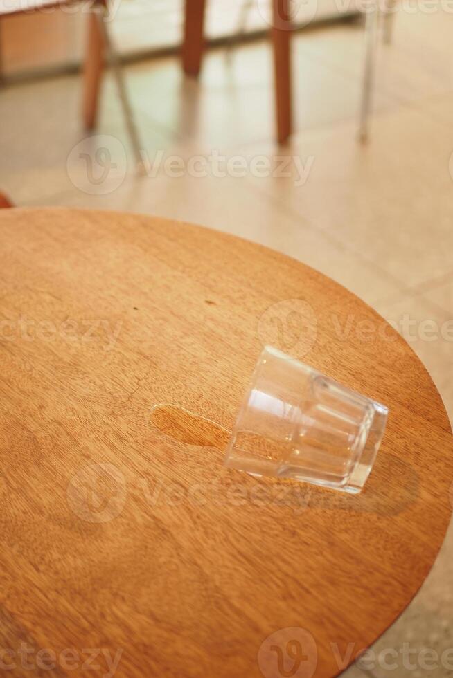 water spilled from a glass on a table photo