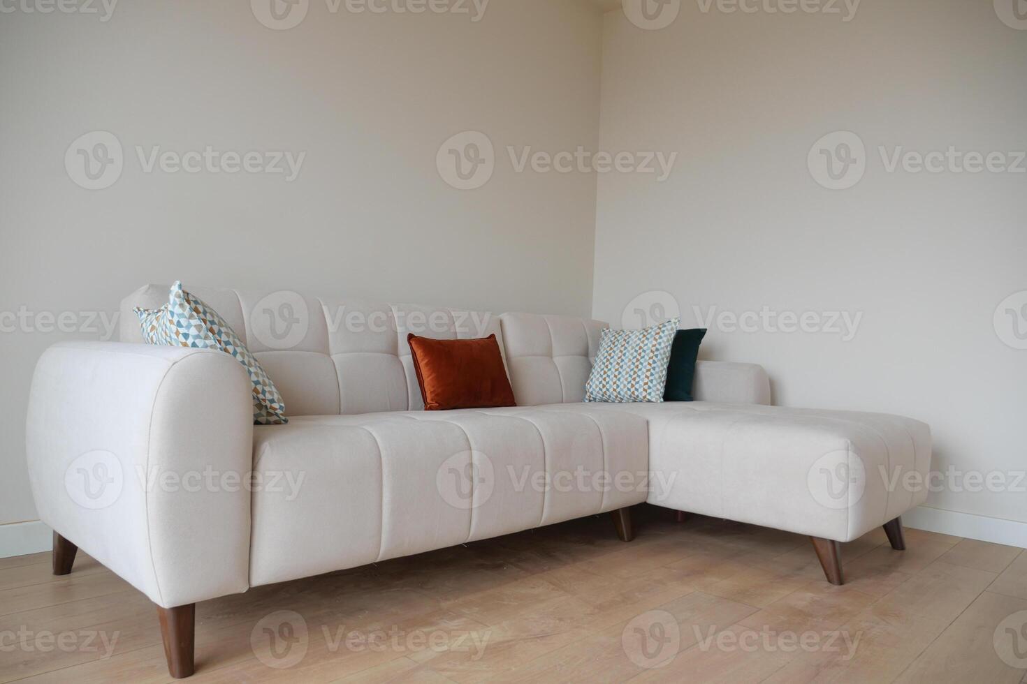 Elegant modern sofa with decorative cushions in bright interior space photo