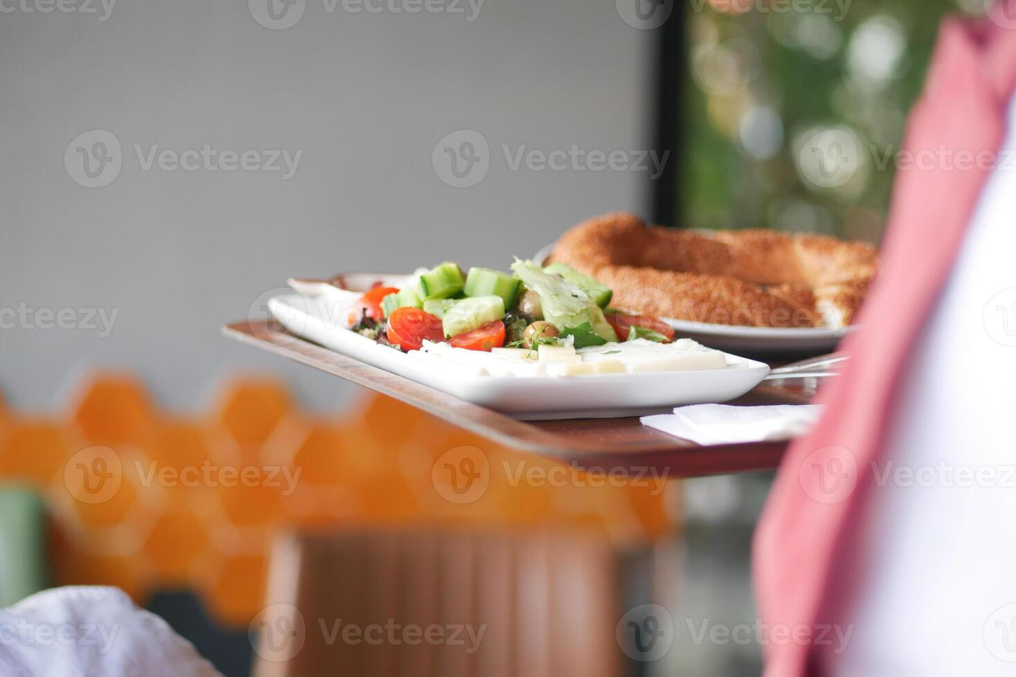 Freshly prepared plate with salad and bread in a cozy cafe setting photo