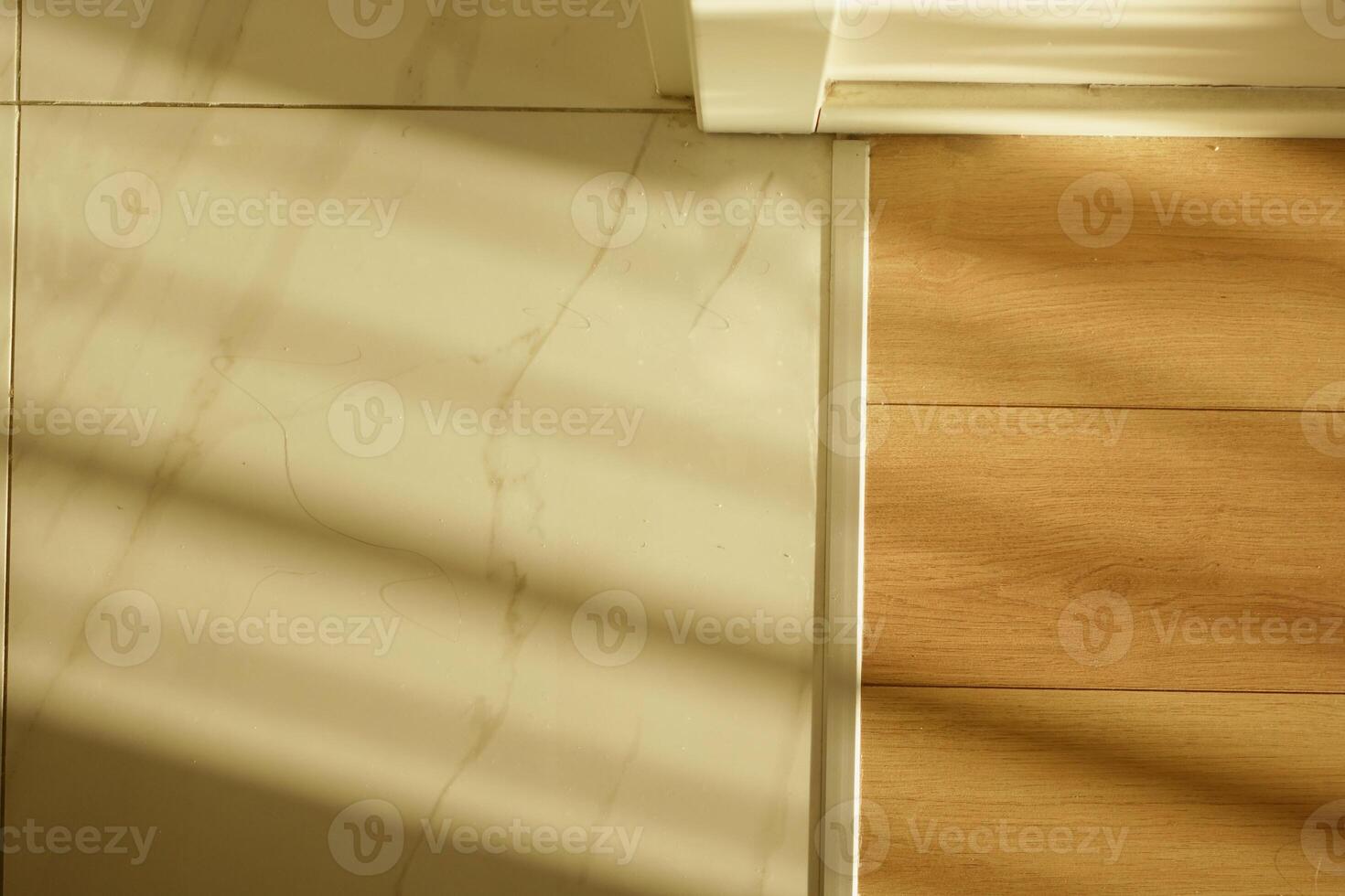 Flooring transition in natural light creates visual contrast indoors photo