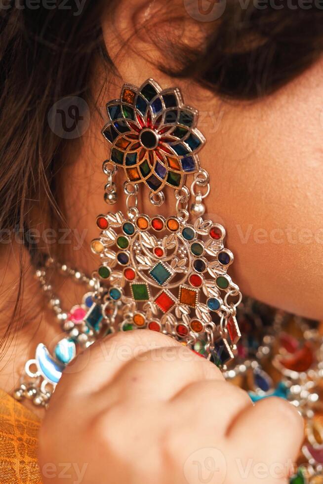 Colorful traditional earrings highlighted in vibrant fashion detail photo