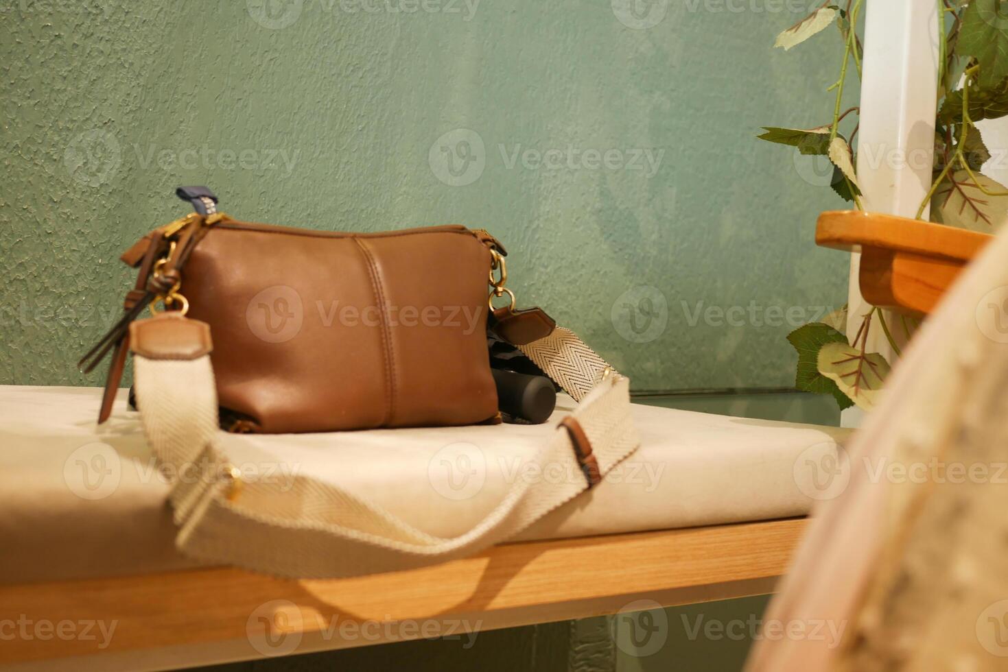 Stylish brown bag resting on a light wooden surface in a cozy setting photo