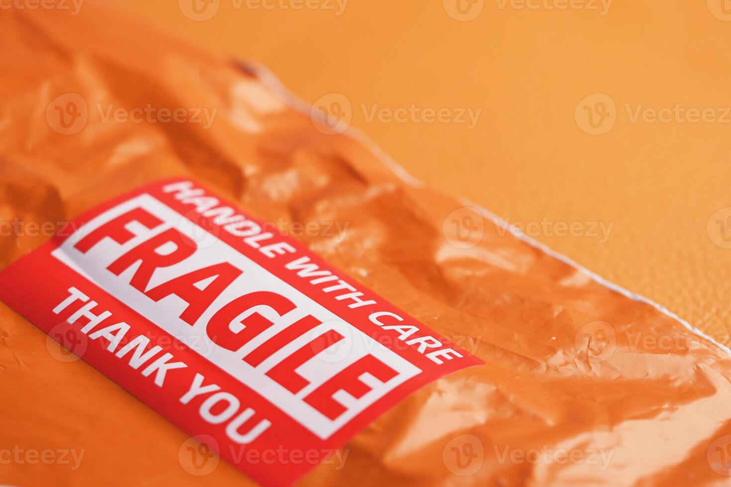 Orange package with fragile label ready for careful handling photo