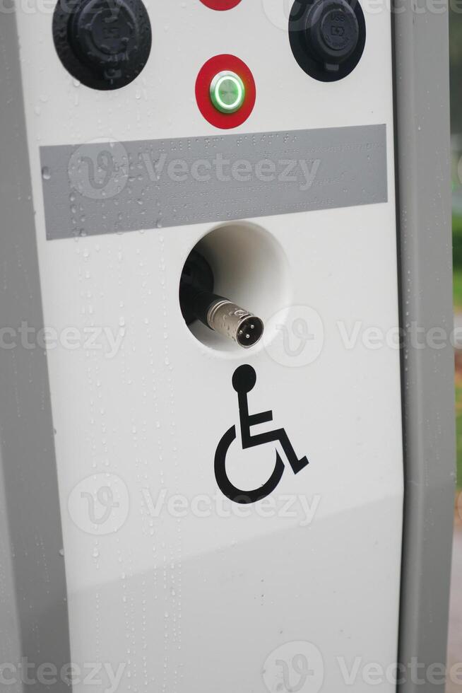 Accessible charging station with disability symbol at public location photo