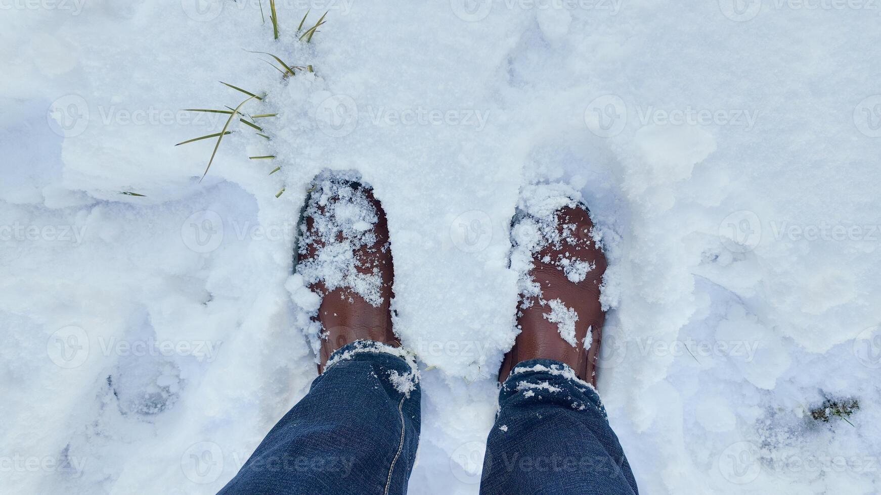 Feet in snowy terrain during a winter day outdoors photo