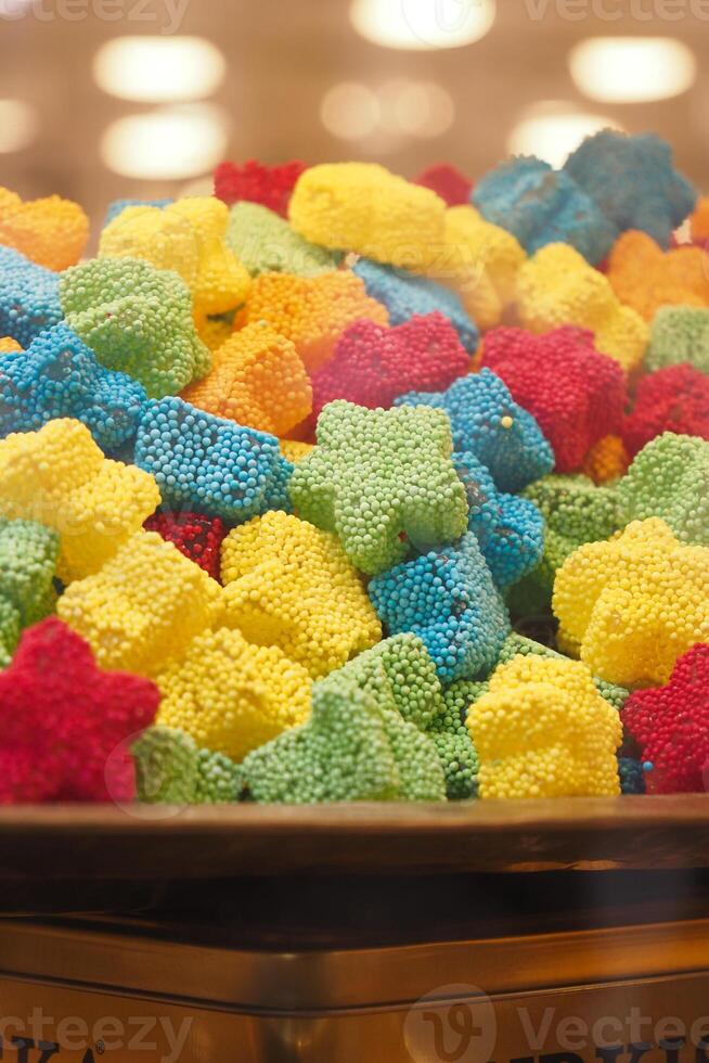 Colorful gummy candy assortment displayed in a glass container photo