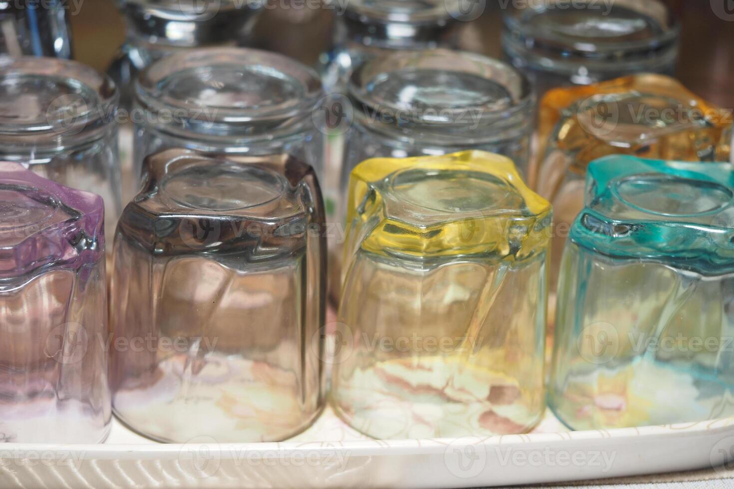 Colorful glass jars arranged on a white tray in a cozy cafe setting photo