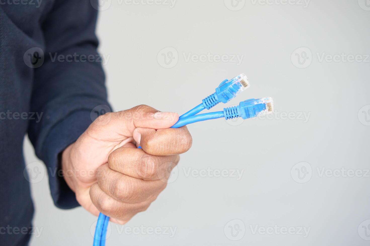Holding multiple blue network cables for connection setup photo