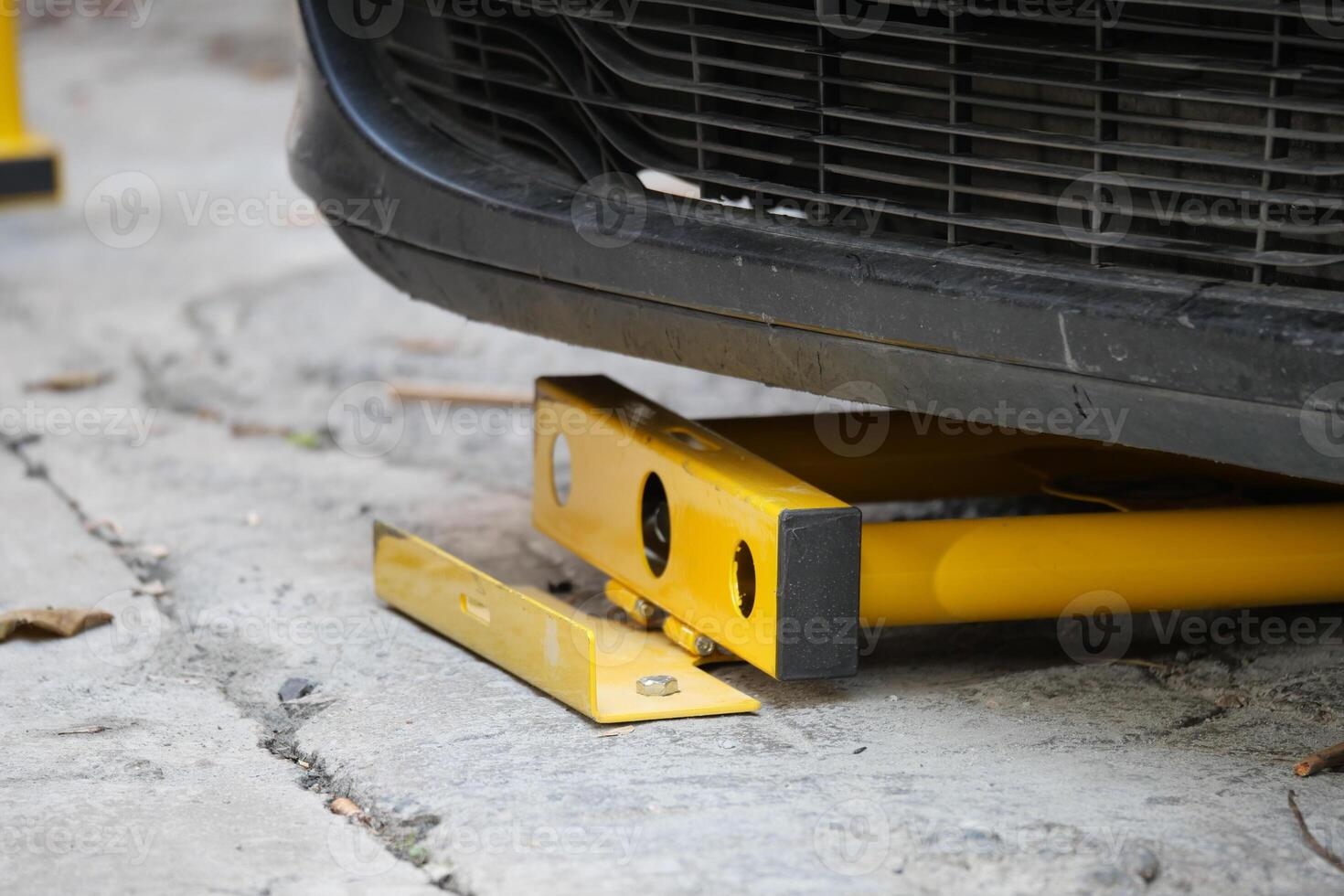 Car immobilizer device used on vehicle in urban parking area photo