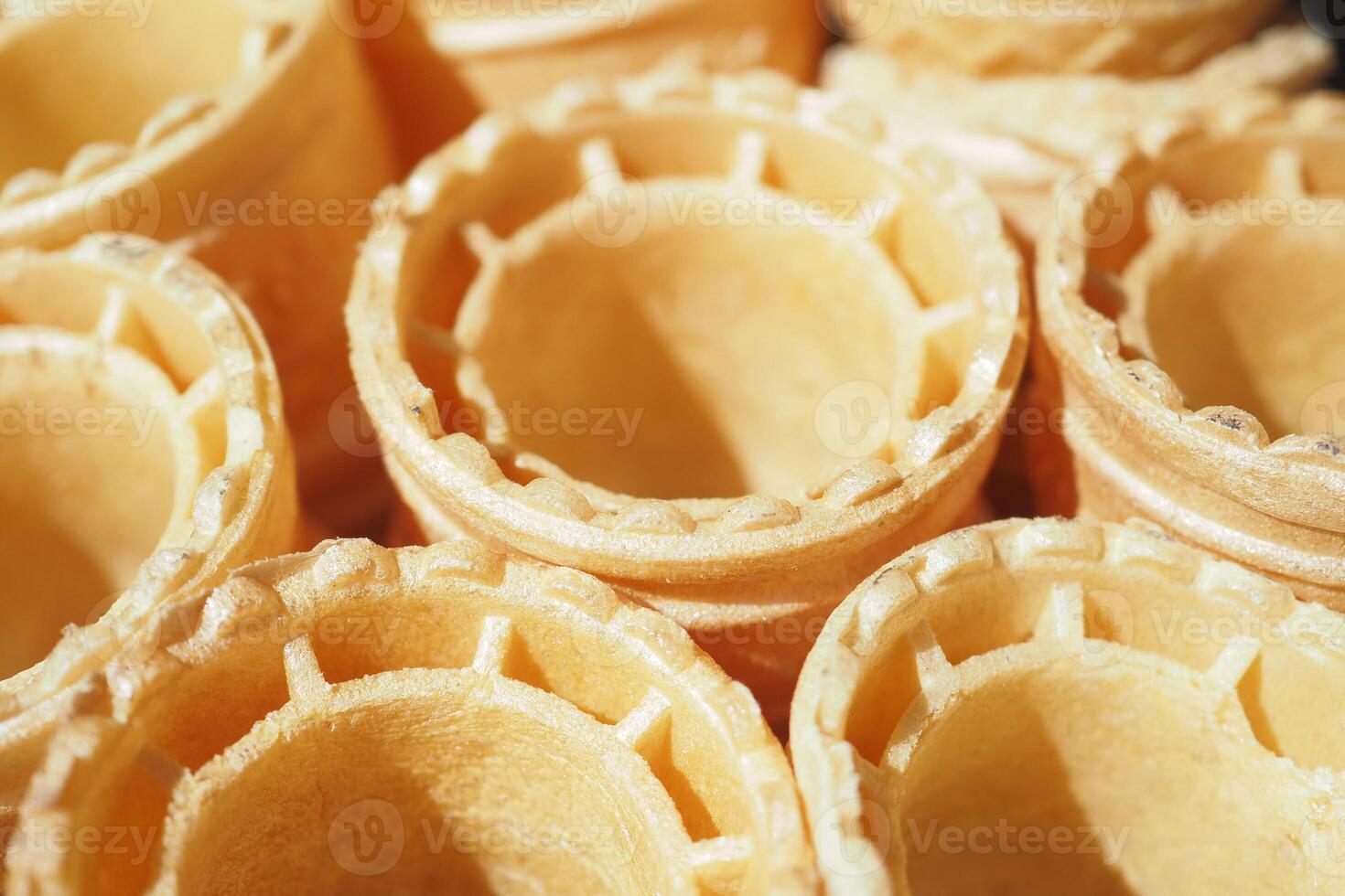 Waffle cones stacked in a bakery ready for filling with ice cream photo