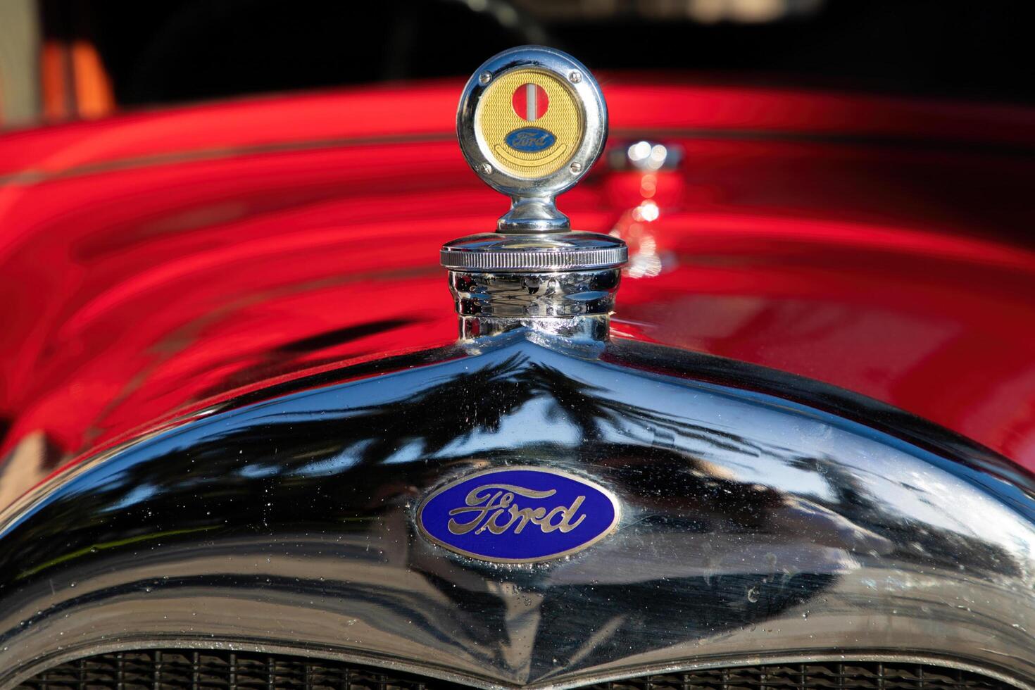 Cartagena, Spain - April 3, 2024 . Close-up of vintage ford car hood ornament and logo on red classic vehicle. High quality photo