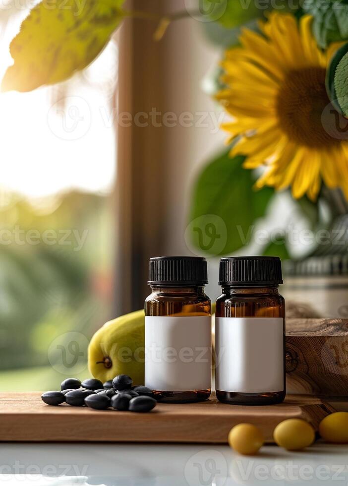 Two bottles of essential oils on a table with sunflowers photo
