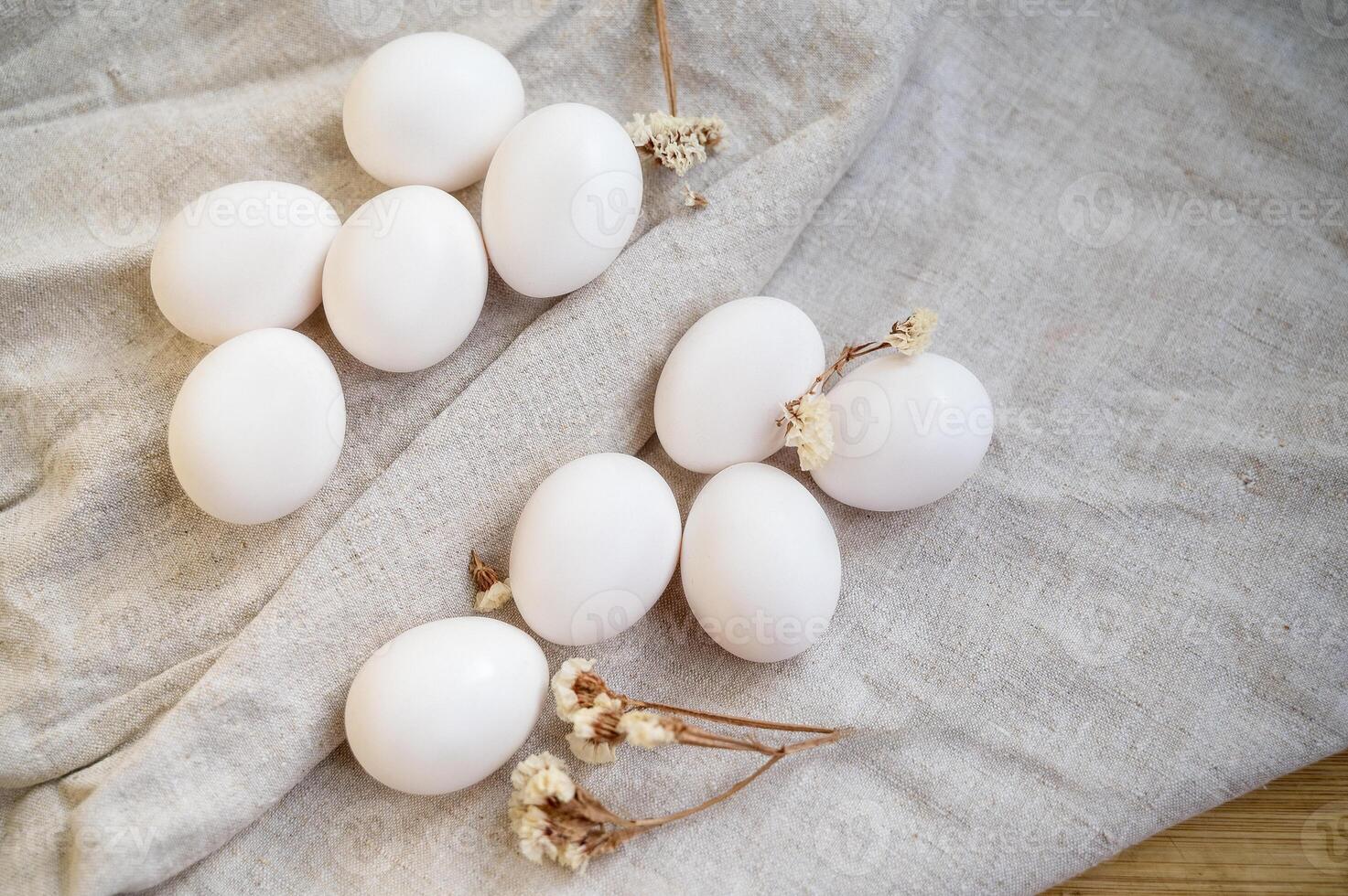 white chicken eggs lie on the table on a natural linen tablecloth. preparation for Easter. healthy food photo