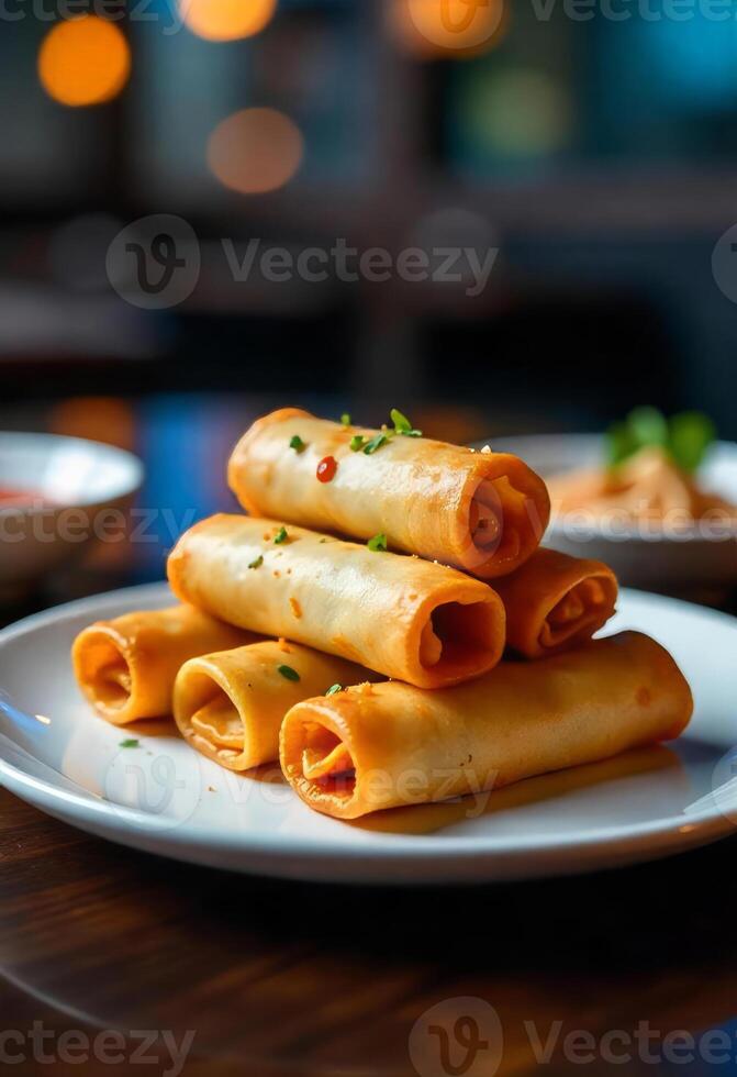 A stack of six golden spring rolls on a white plate, garnished with herbs and a drizzle of sauce, restaurant background photo